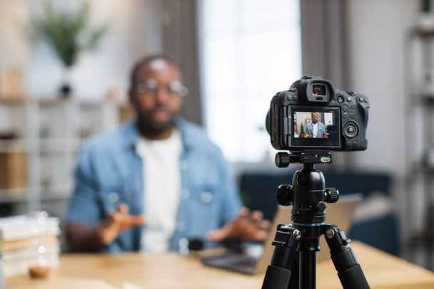 African guy recording new video blog on digital camera - Photo, image