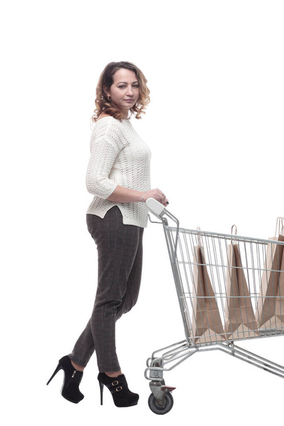 casual young woman with shopping cart. isolated on a white - Фото, изображение