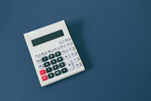 calculator on a blue background - Foto, imagen