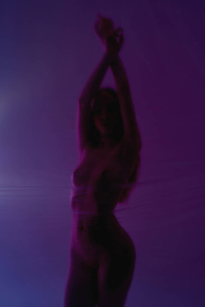 Dark view of girl behind transparent oilcloth - Valokuva, kuva