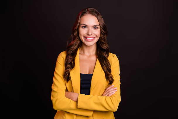 Photo of cheerful positive young woman dressed yellow blazer hands folded smiling isolated black color background - Foto, afbeelding