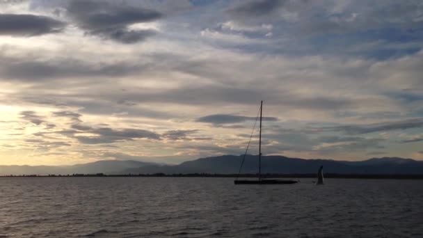 Sunset and sailboat while leaving keramoti, Greece - Materiał filmowy, wideo