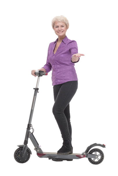 smiling mature woman with an electric scooter . - Фото, зображення