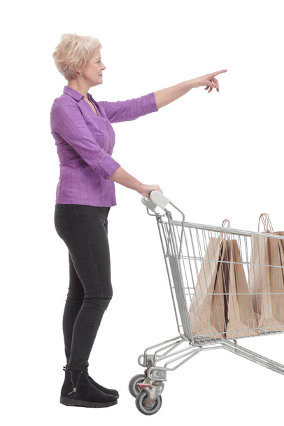 in full growth. casual mature woman with shopping cart. - Fotó, kép