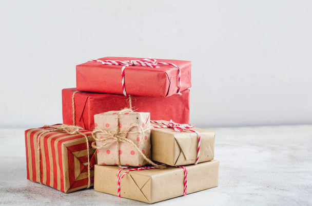 Modern Christmas wrapped presents with natural decor in kraft paper. Christmas zero waste, ecological concept of eco-friendly. vintage retro style,  - Foto, Imagem