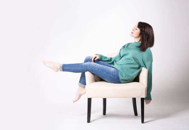 Uma jovem empresária de jeans e uma camisola com uma pasta de couro - Foto, Imagem