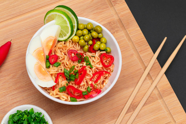 Beautiful Noodle Dish with Green Pea, Eggs, Red Hot Pepper, Greens and Lime - Photo, Image