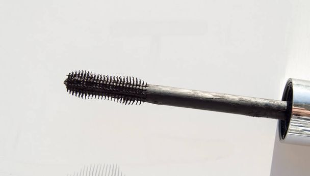 Close-up of a black mascara brush isolated on a white background. - Photo, Image