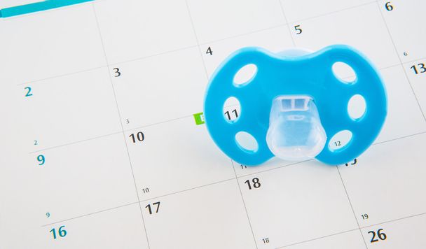 Blue Pacifier and Calendar - Photo, Image