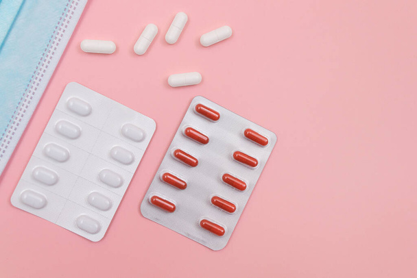 Different Pills and Tablets Package on Pink Background - Fotoğraf, Görsel