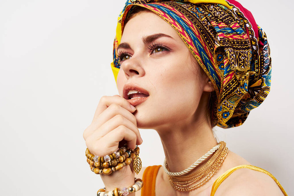 beautiful woman multicolored shawl ethnicity african style decorations light background - Фото, изображение