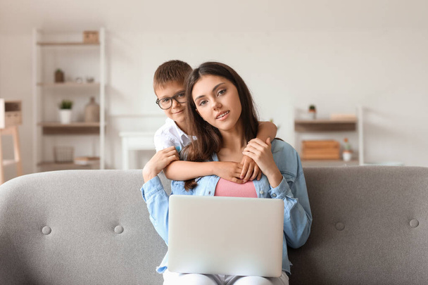 Tinédzser lány laptoppal és az öccse otthon - Fotó, kép