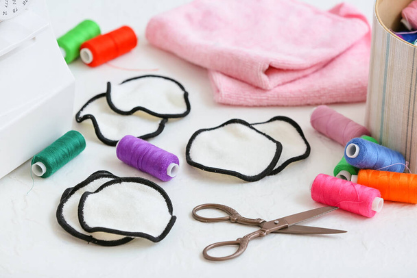 Handmade cotton pads with threads and scissors on white background - Photo, Image