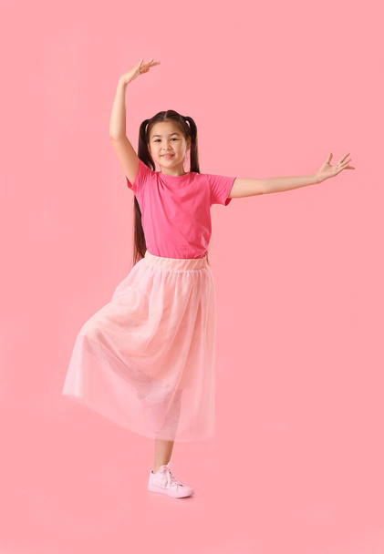 Dancing little girl on color background - Фото, изображение