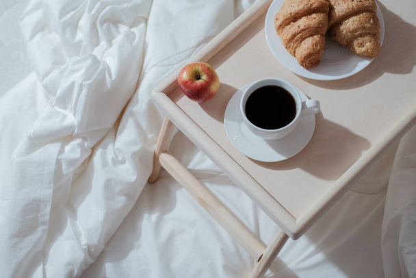 Breakfast on wooden table for bed. Coffee, cake and apple for healthy morning eating.  - Fotografie, Obrázek