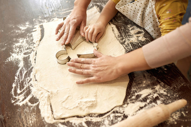 Cropped of relatives using dough mold in dough - Foto, Imagen