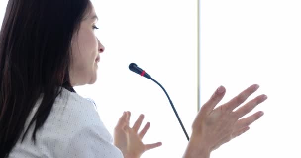 Woman speaker talking into microphone at business conference 4k movie slow motion - Footage, Video