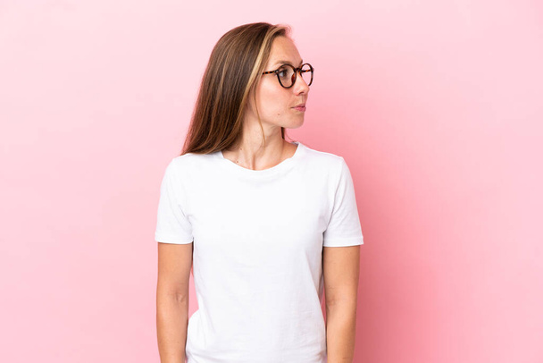 Young English woman isolated on pink background looking to the side - Photo, Image
