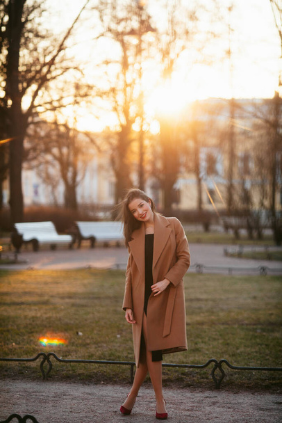 girl in coat in the street at sunrise - Φωτογραφία, εικόνα