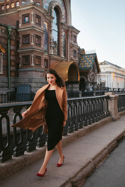 girl in coat in the street at sunrise - Zdjęcie, obraz