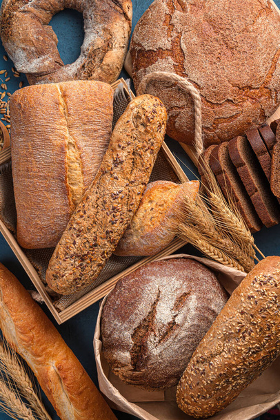 Vers, knapperig brood van verschillende soorten en tarwe close-up. Bovenaanzicht. Broodfonds. - Foto, afbeelding