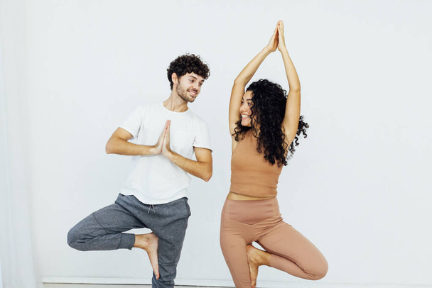 man and woman engaged in yoga asana gymnastics - Foto, Bild