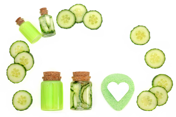 Natural fresh cucumber skincare beauty treatment with moisturiser, gel in bottles, green sponge, soap. Health care anti ageing radiant skin concept. On white background. - Foto, Bild