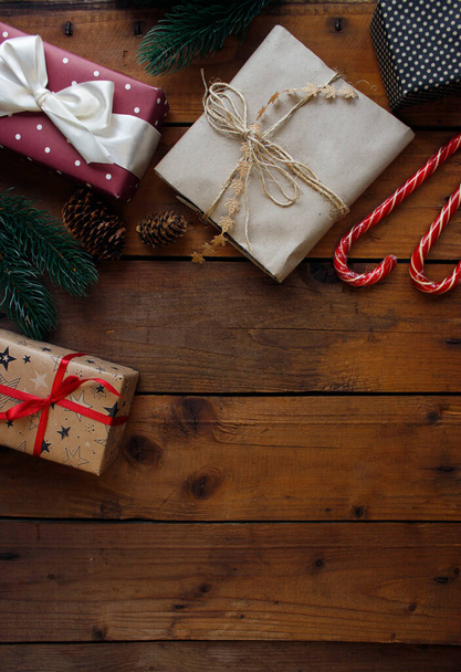 Christmas and New Year holiday background. Christmas gifts on wooden background top view. Flat lay - 写真・画像