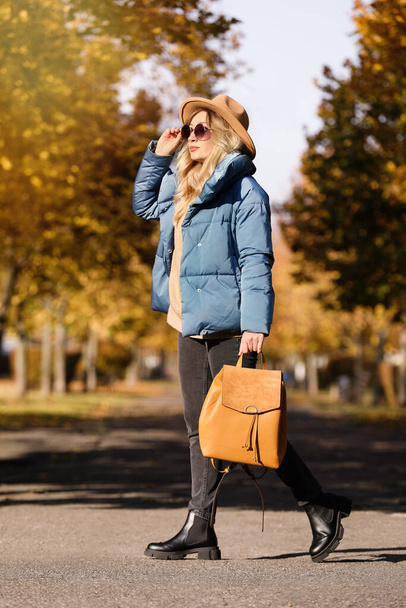 Young woman with stylish backpack on autumn day - Fotó, kép