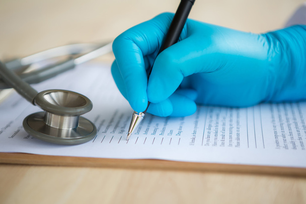 Hand of doctor writing on prescription - Фото, зображення