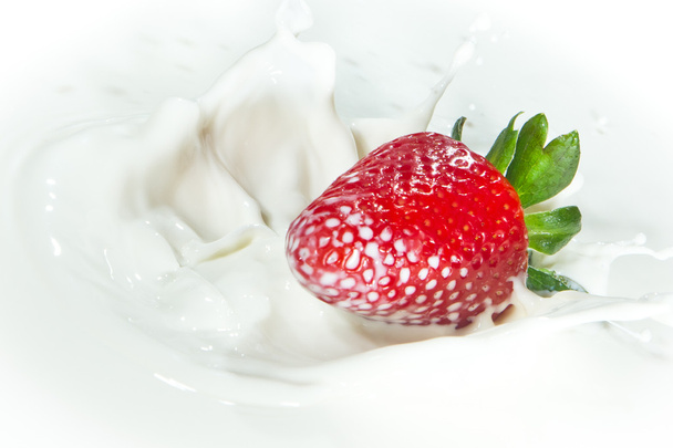 Strawberry splashing into milk - Photo, Image