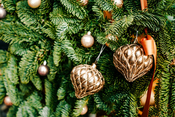 Beautiful Christmas tree decoration with garland and baubles on blurred background. - Фото, зображення