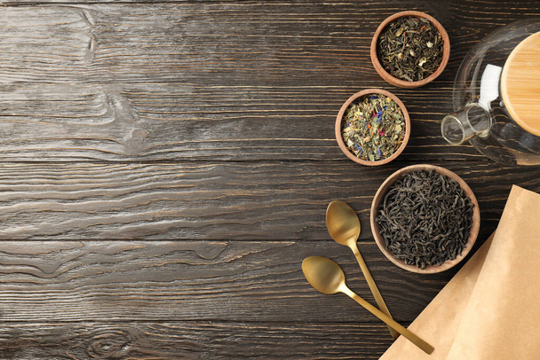 Concept of cooking tea with different types of tea on wooden background - Photo, image