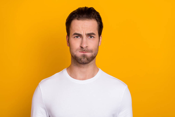 Photo of youngster man pouted cheeks grimace hold breath humorous isolated over yellow color background - Fotoğraf, Görsel
