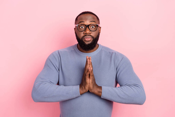 Photo of nervous guy dressed grey sweater spectacles arms together asking forgiveness isolated pink color background - Foto, immagini