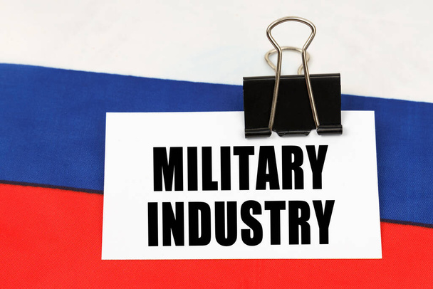 National concept. On the flag of Russia there is a business card with the inscription - Military industry - Foto, Bild