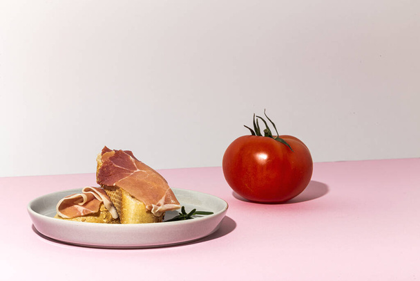 Traditional Spanish Iberian Serrano Ham with tomato. Parma ham Italian antipasto - Фото, зображення