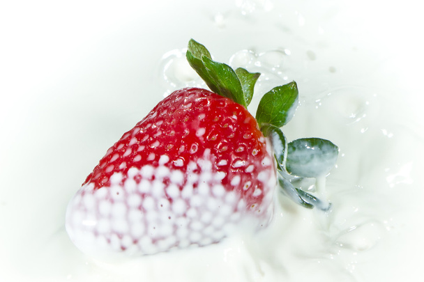 Strawberry splashing into milk - Fotoğraf, Görsel