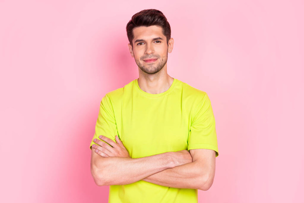 Photo of optimistic brunet hairdo millennial guy crossed arms wear green t-shirt isolated on pink color background - Photo, image
