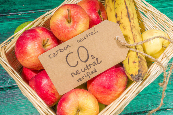 Углероднонейтральный, не содержащий CO2 концептуальный продукт. Природные органические яблоки фермы фрукты, с углекислым газом проверены, на деревянном столе в магазине фермы - Фото, изображение