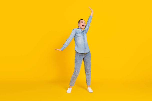 Full length body size photo cheerful careless girl laughing dancing at party isolated bright yellow color background - Foto, Imagen