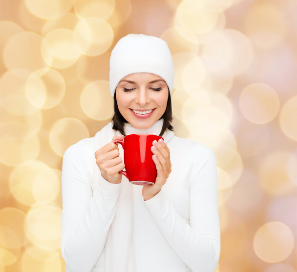 smiling young woman in winter clothes with cup - Φωτογραφία, εικόνα