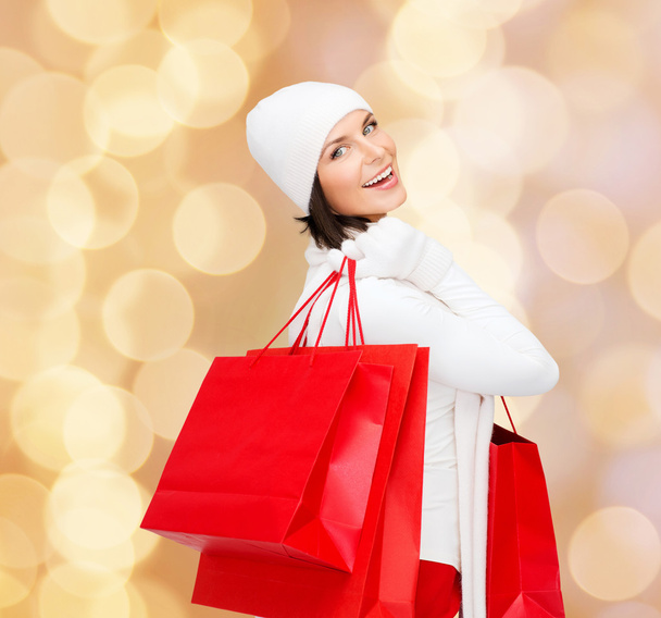 smiling young woman with red shopping bags - Photo, Image