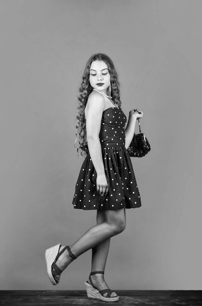 Fast fashion essentially business model companies that manufacture products. Retro fashion. Movement towards vintage fashion. Little girl makeup face curly hairstyle vintage outfit. Luxurious style - Zdjęcie, obraz