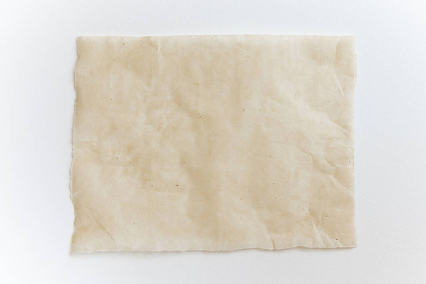 Baking paper sheet isolated on white background, top view. Parchment for baking culinary. - Фото, зображення