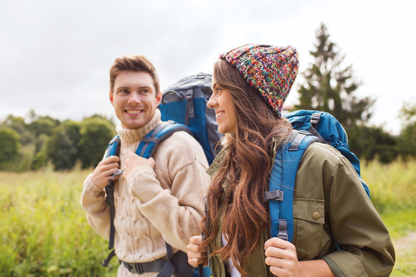 smiling couple with backpacks hiking - Φωτογραφία, εικόνα