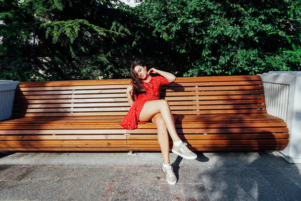 beautiful brunette woman in summer red dress walking outside - Φωτογραφία, εικόνα
