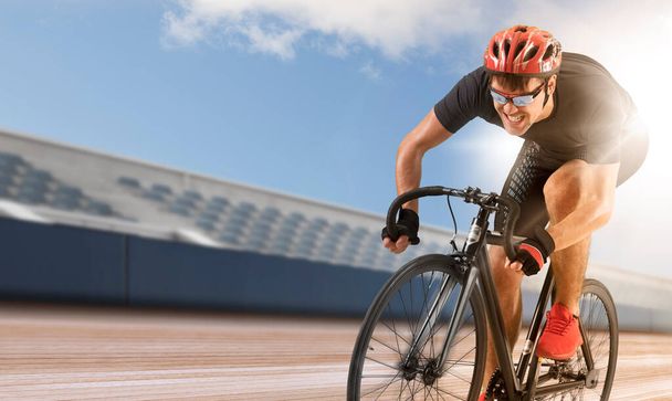 Man racing cyclist in motion on track background. Concept of sport, movement, energy, dynamic, healthy lifestyle - Foto, afbeelding