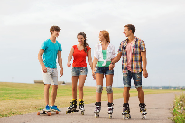 group of smiling teenagers with roller-skates - Foto, Imagem