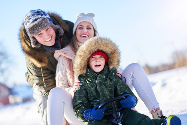 Nice happy family having fun on winter snow - Foto, Imagen